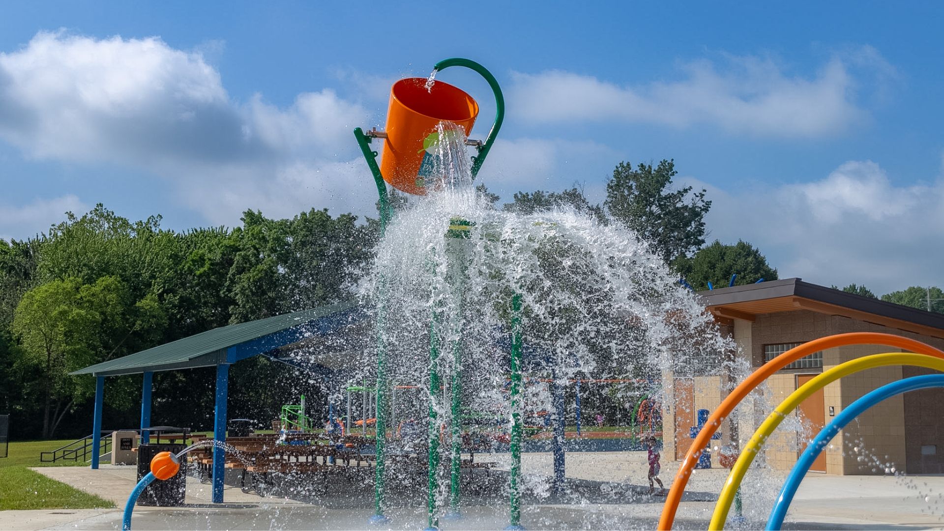 A west side park that once sat waiting for its next chapter is now filled with summer noise again — water spraying, basketballs bouncing, pickleball paddles popping, and children testing out a new playground.